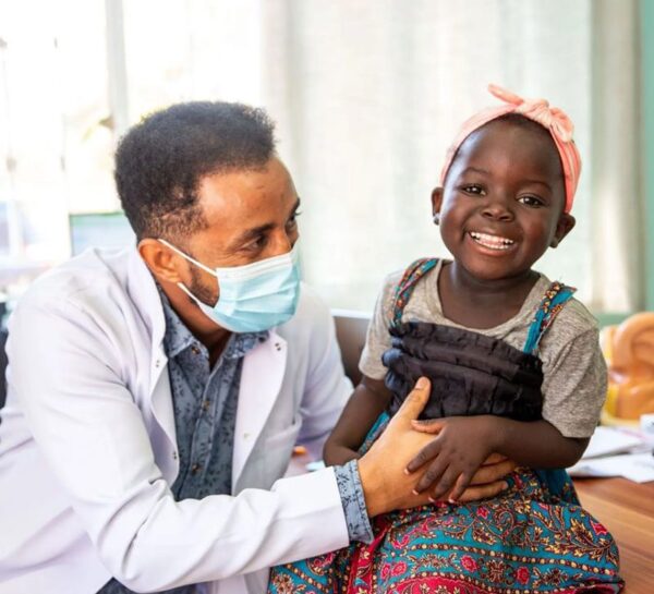 Doctor talking to smiling girl