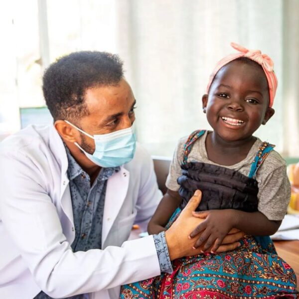 Doctor talking to smiling girl