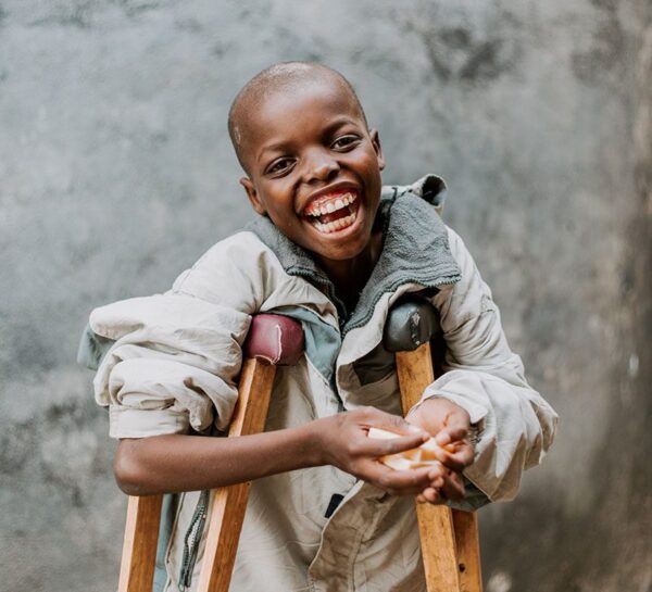 child laughing with crutches