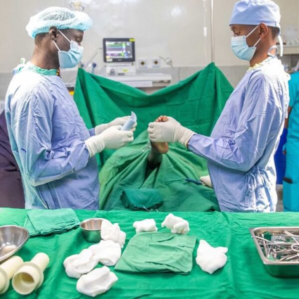 Surgeon holding a childs foot